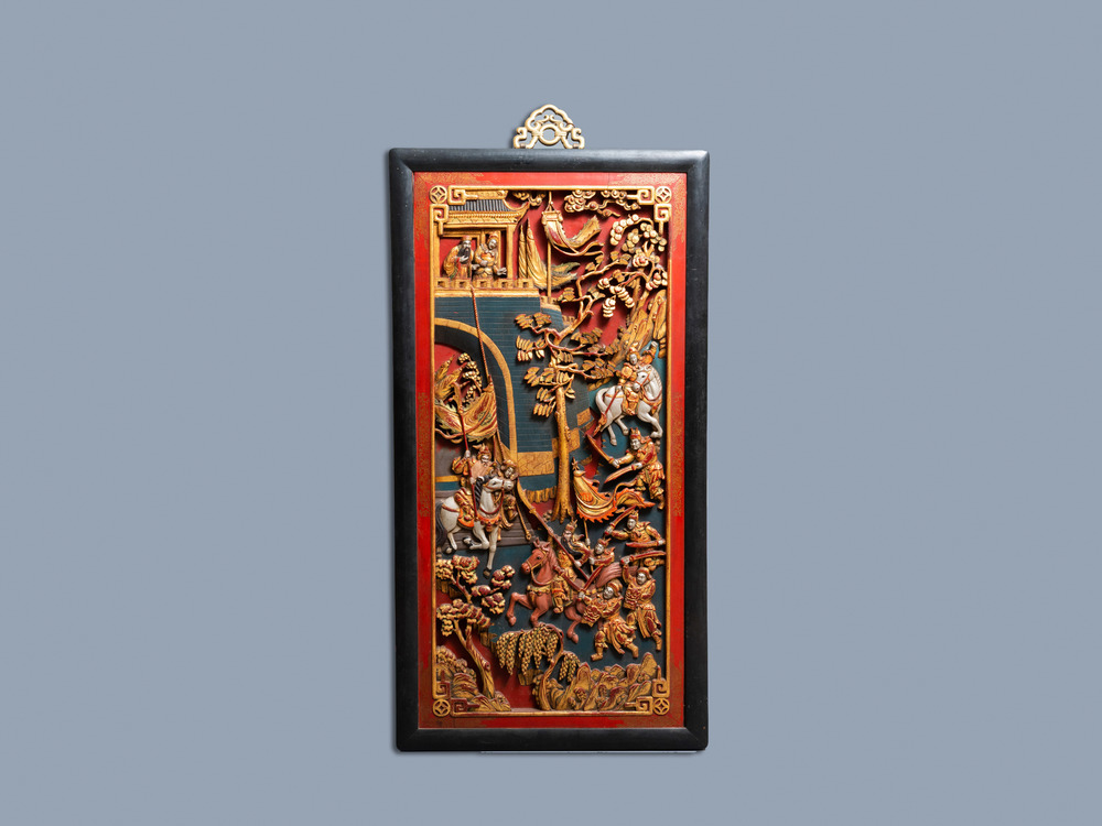 A Chinese lacquered and polychromed carved wooden panel, 19th C.